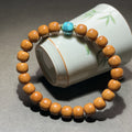 Houtou wenwan 8x9mm old-shape barrel bead bracelet with turquoise-tone focal bead and gold-tone spacers