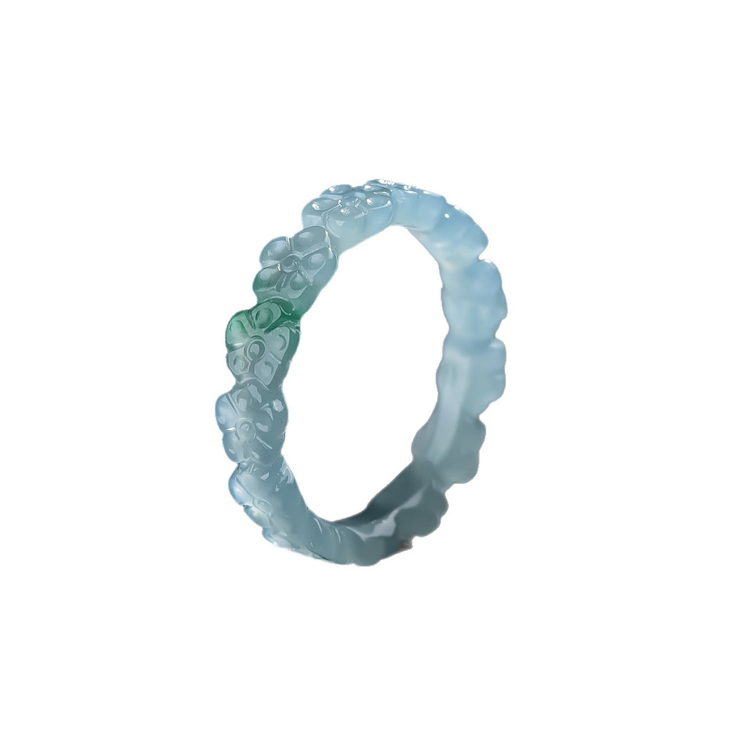 Icy blue water jadeite floral ring with clever green accent under light