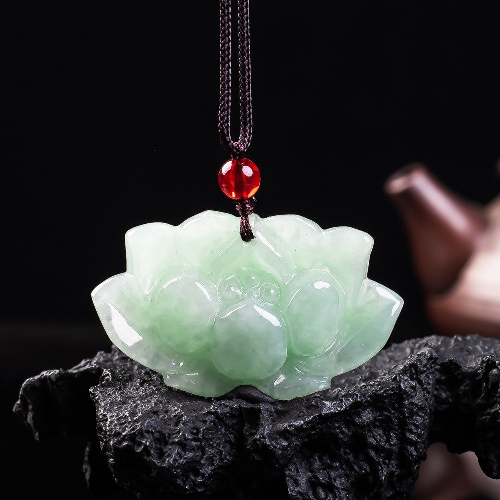 Carved icy green jadeite lotus flower with red accent bead and cord