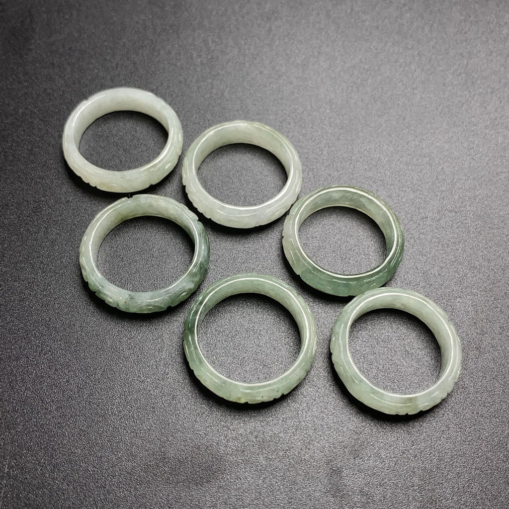 Icy pale green jadeite carved key fret rings showing traditional meander edge pattern