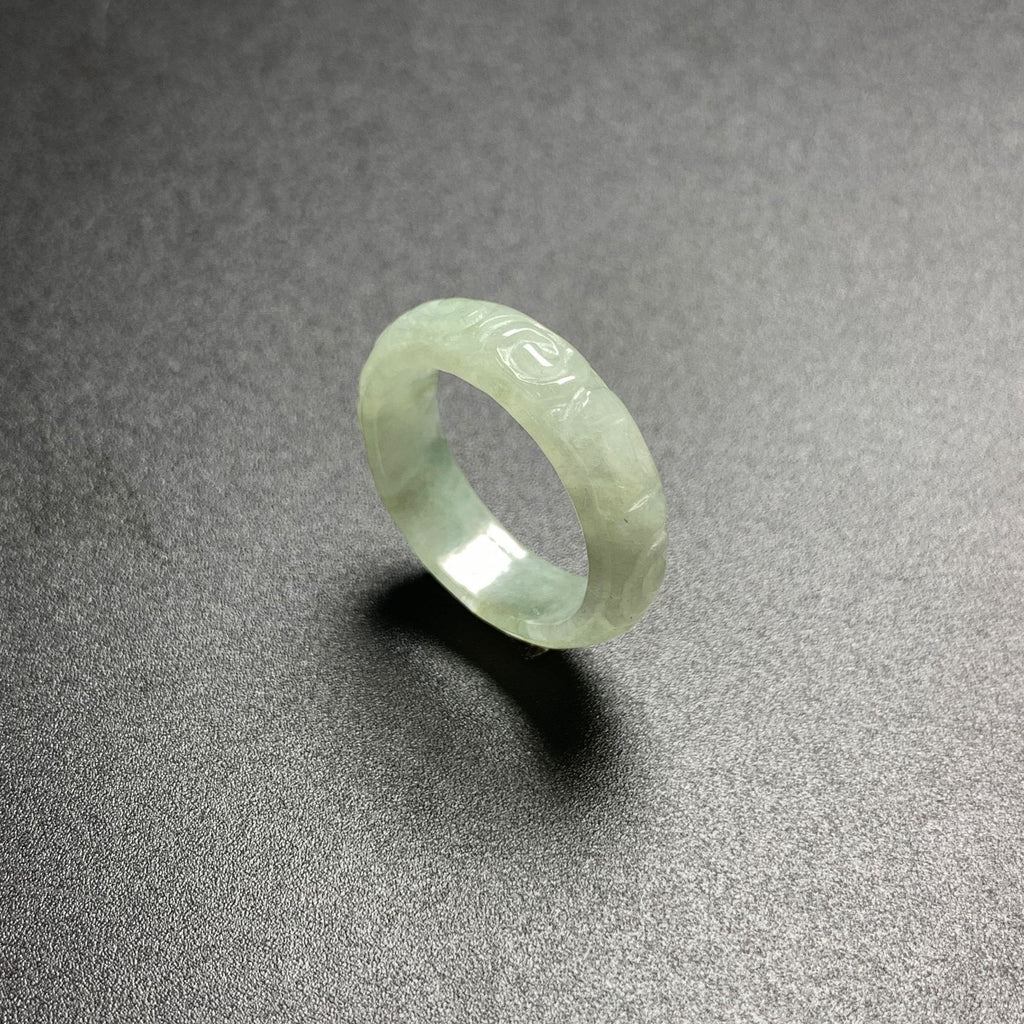 Pale green carved jadeite ring showing translucent icy glutinous texture
