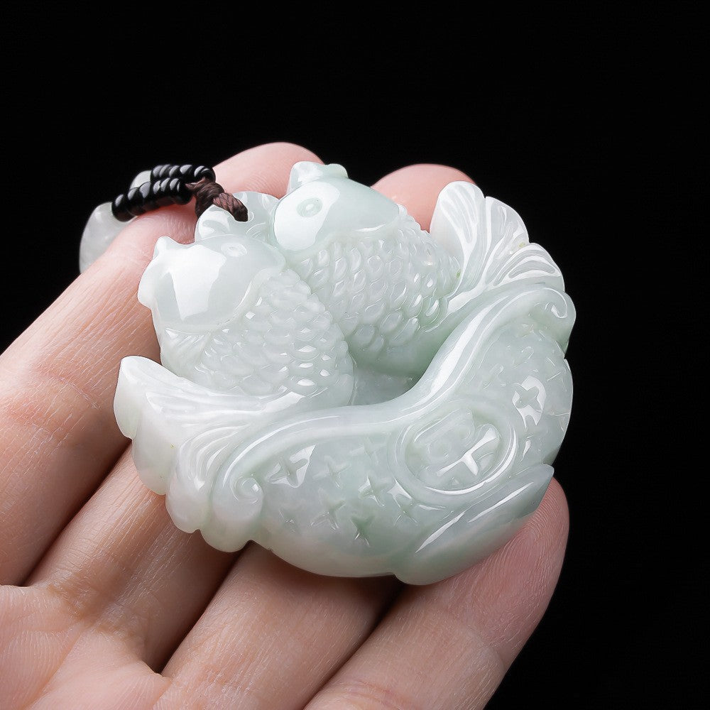 Double-sided jadeite twin fish pendant showing carved scales and bowl motif