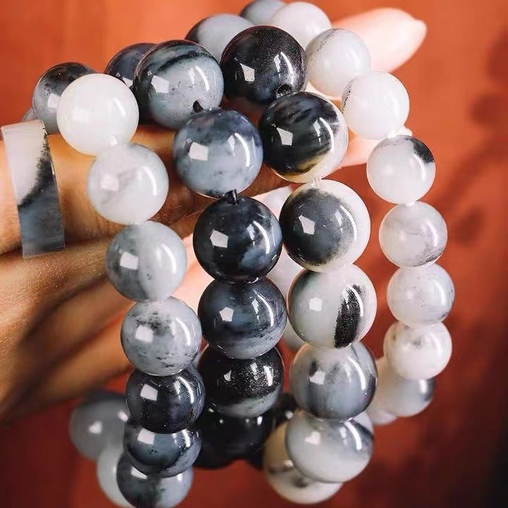 Black white grey stone bead bracelets showing natural pattern variation