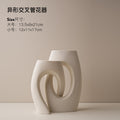 White interlocking loop ceramic vase set in modern sculptural style