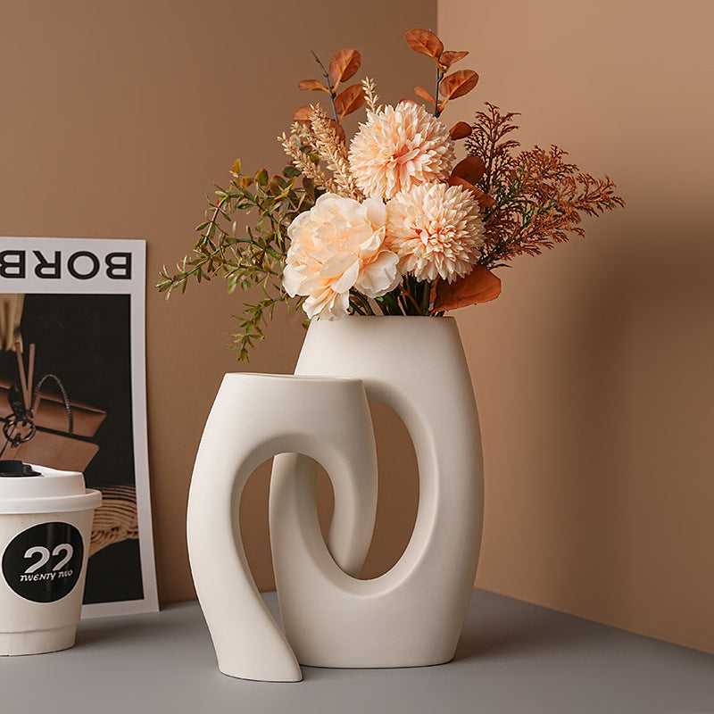White loop vase with autumn floral arrangement
