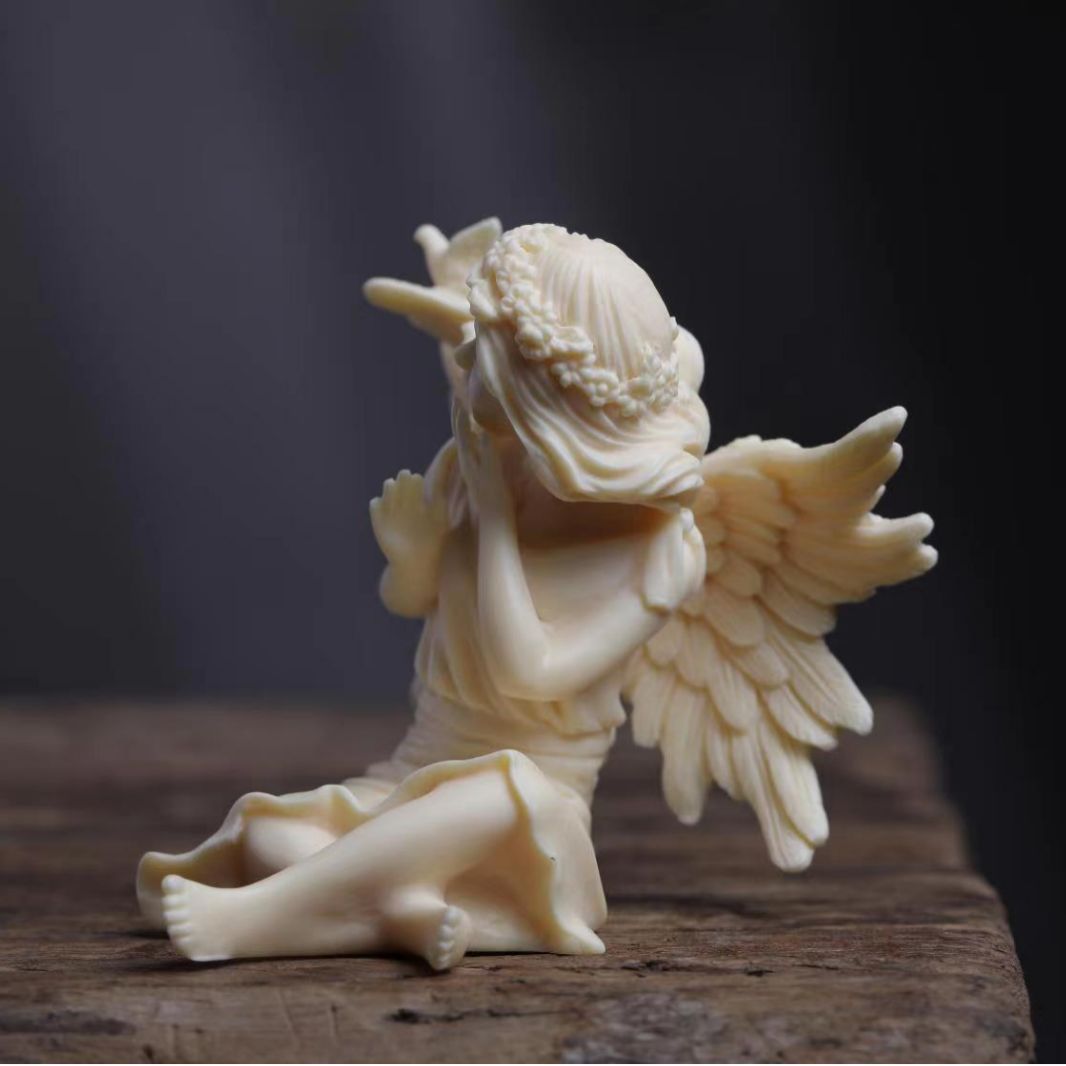 Vegetable ivory angel girl ornament with bird and feather wing details