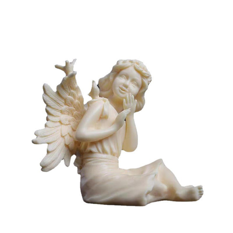 Detail view of ivory nut beauty angel figurine face, hair and feathered wings