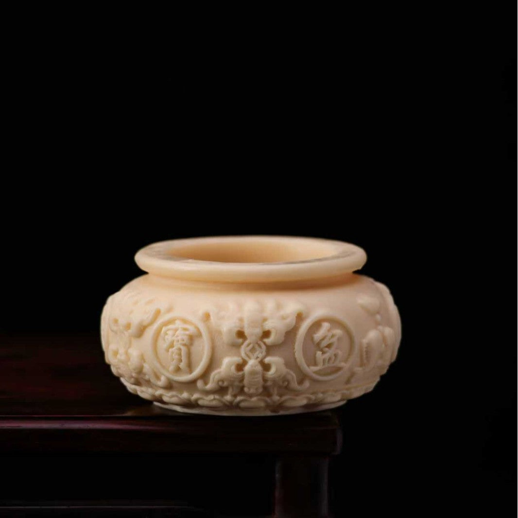 Ivory nut cicada decorative carving shown from side with sculpted wing texture