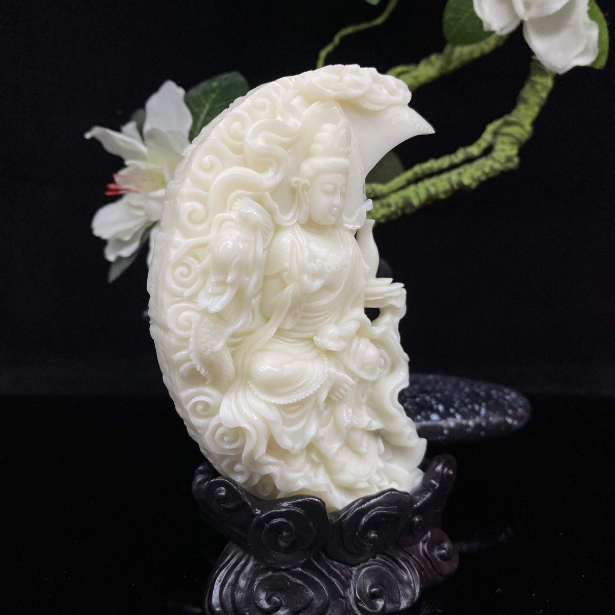 Back view of ivory nut crescent Guanyin statue showing natural vegetable ivory carving and cloud relief