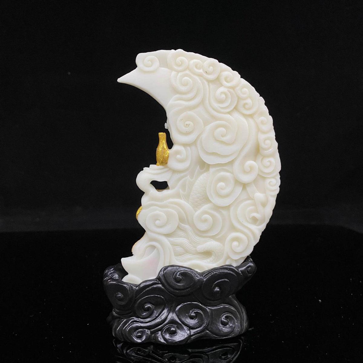 Side and rear detail of ivory nut crescent Guanyin figure with cloud-patterned moon and dark sculpted base