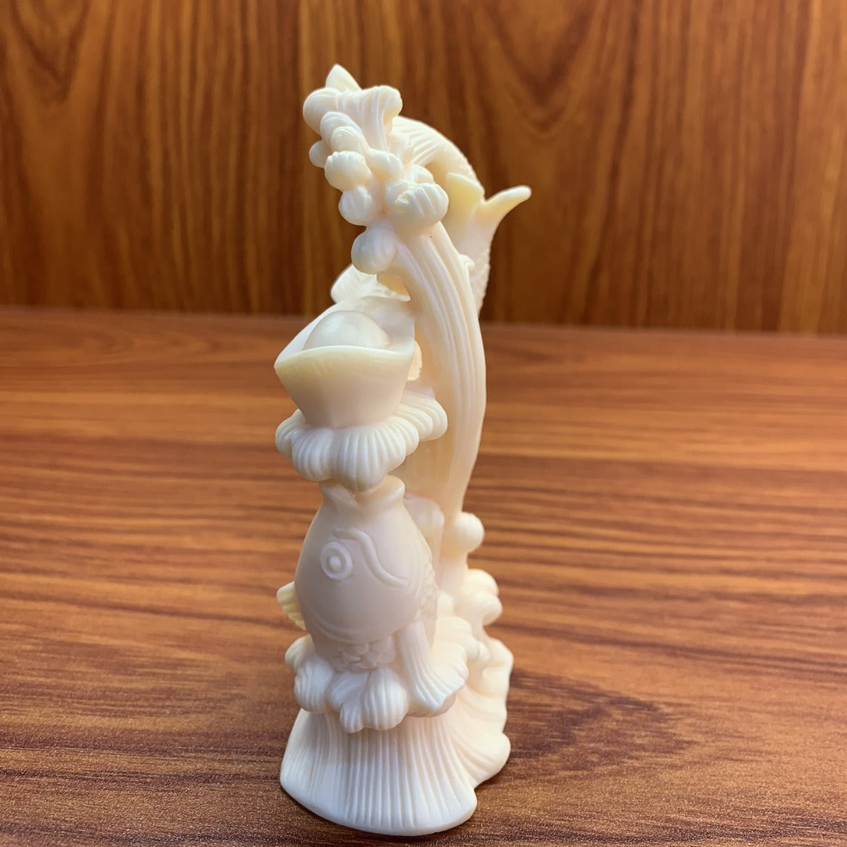 Alternate side view of hand-carved ivory nut double-fish treasure ornament