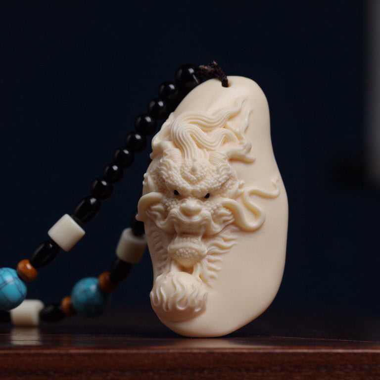 Ivory nut Chinese dragon head relief pendant with natural creamy vegetable ivory finish