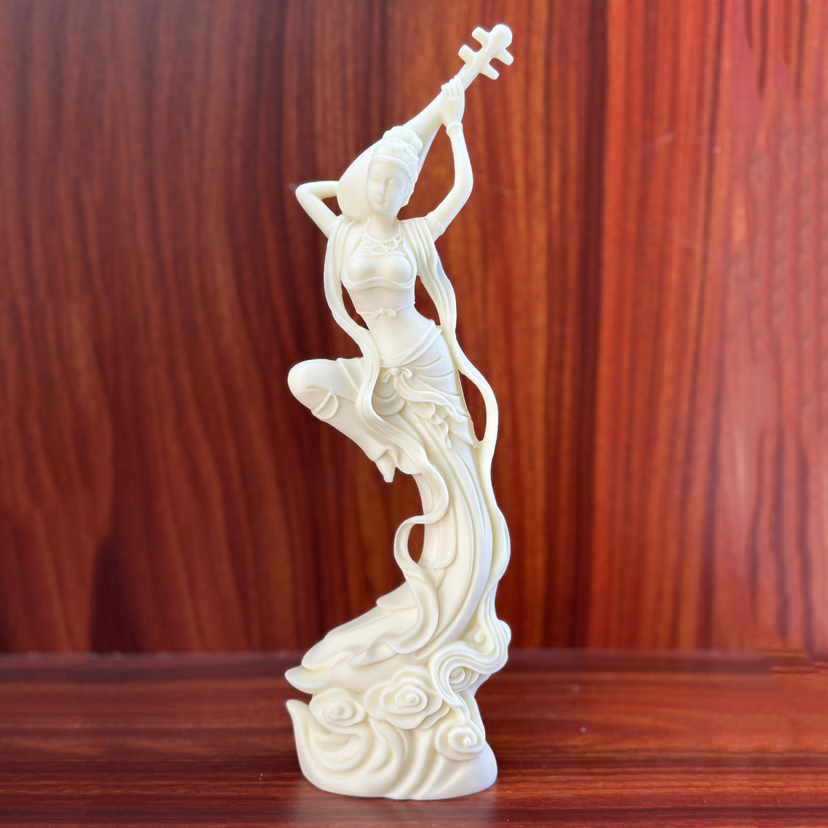 Natural ivory nut Dunhuang flying apsara holding a pipa above her head on a cloud base