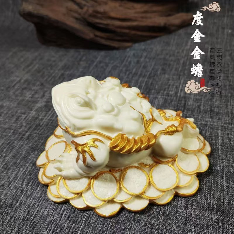Ivory nut golden toad wealth figurine with hand-applied gold-tone accent details on Chinese coin base