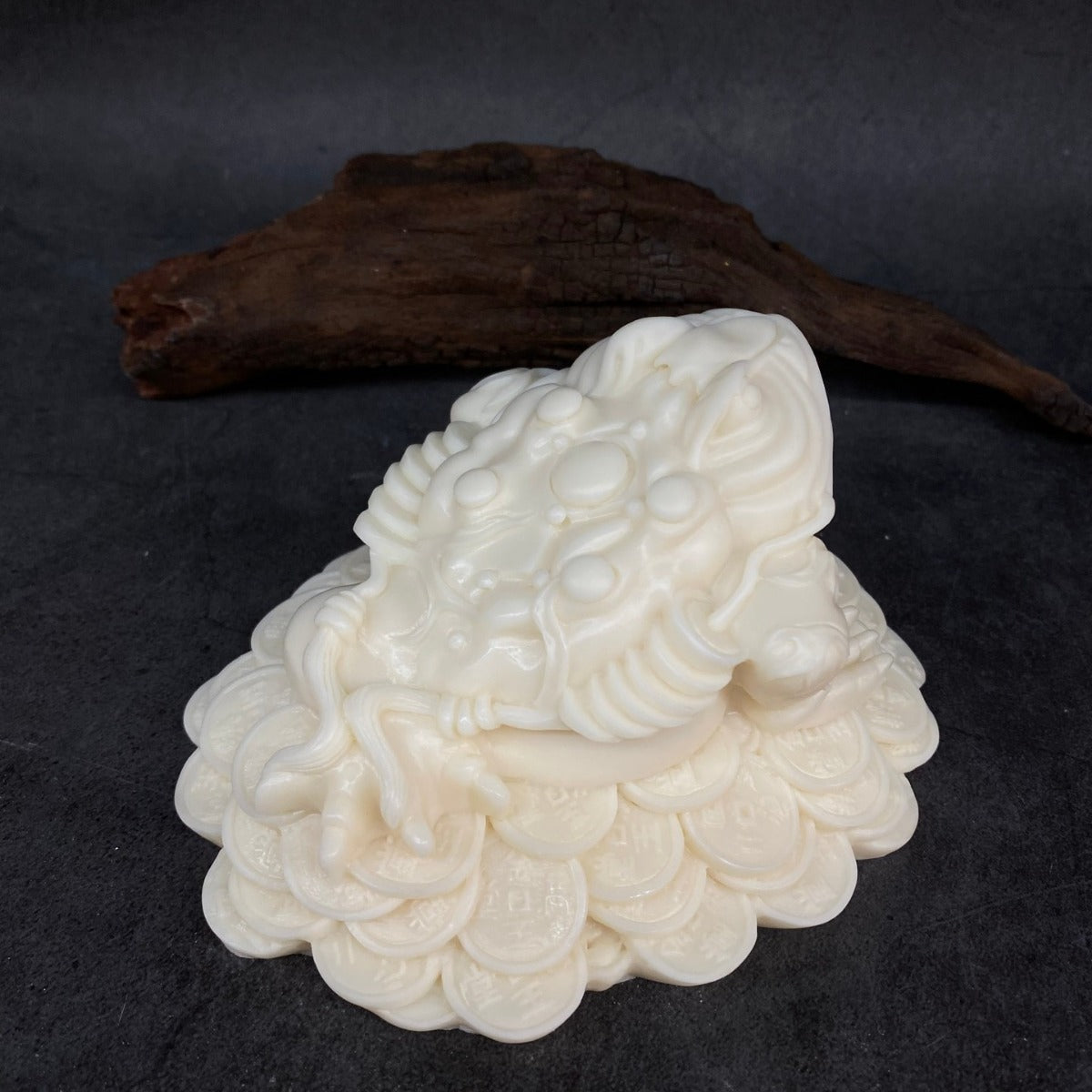 Natural vegetable ivory golden toad figurine with wealth coin motif shown from the front