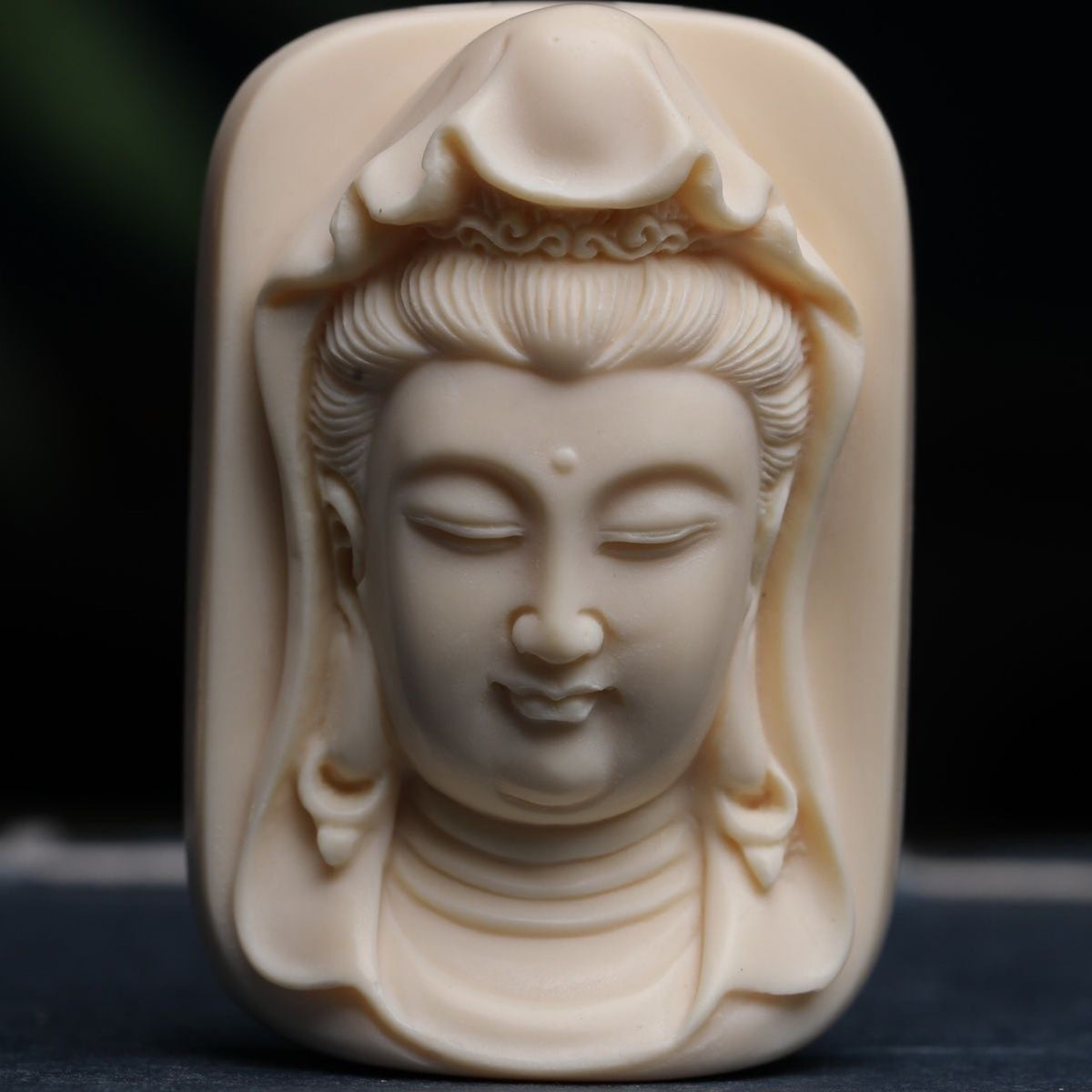 Hand-carved ivory nut Guanyin pendant and decorative ornament in warm ivory tone
