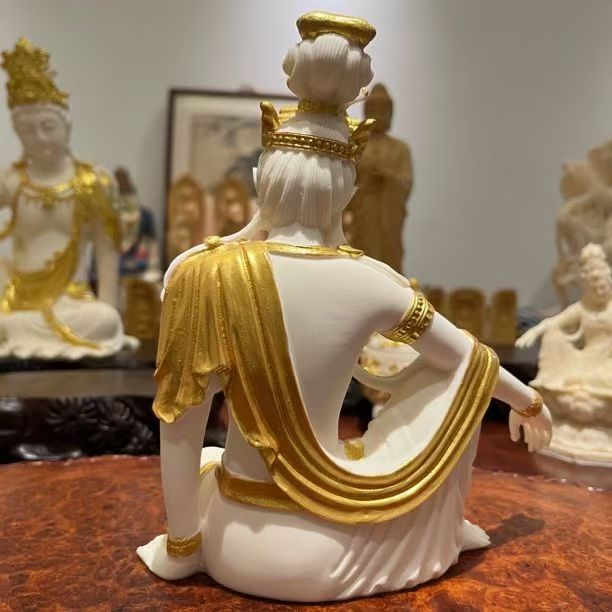 Ivory nut Guanyin statue decorative carving shown in a refined Chinese-inspired setting