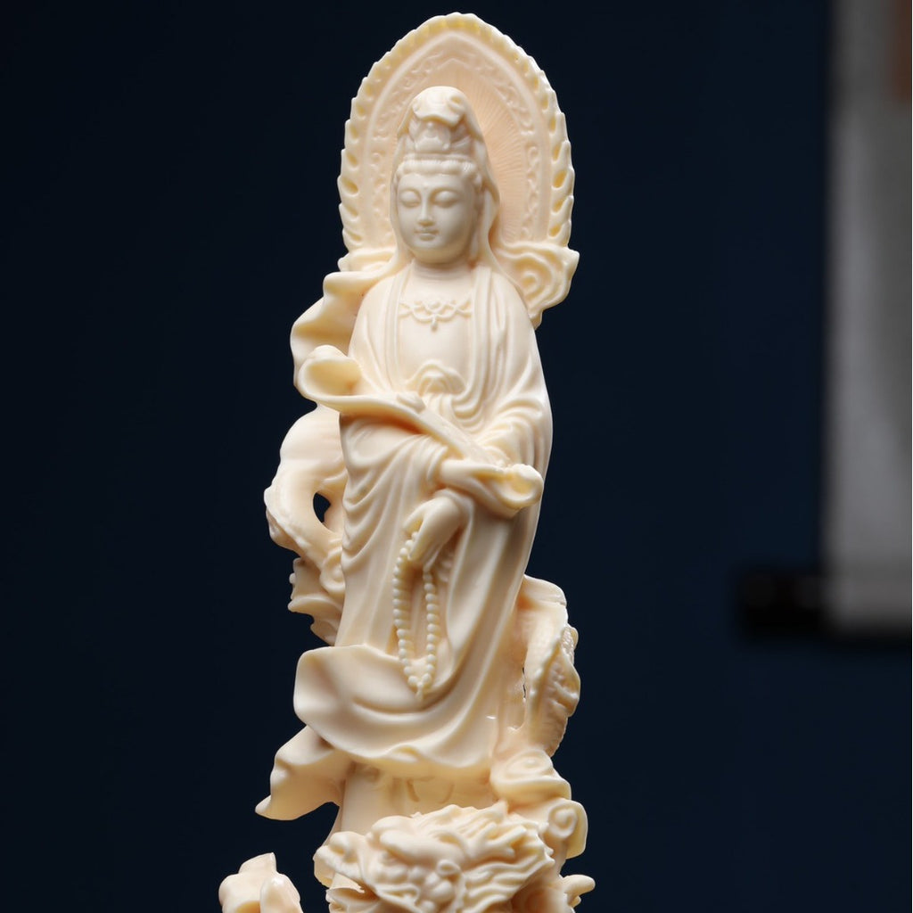 Ivory nut Guanyin statue with dragon base, ruyi-like form and halo in creamy vegetable ivory tone