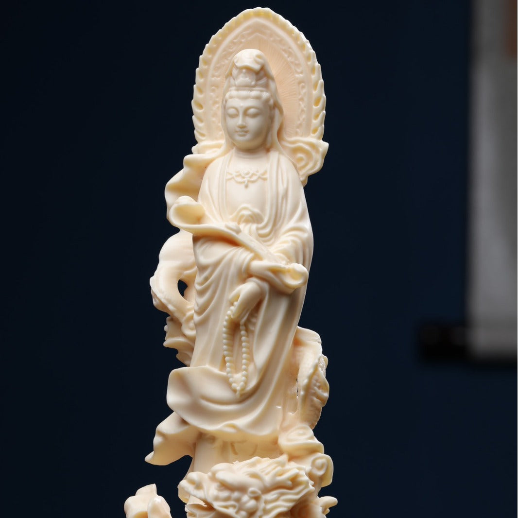 Ivory nut Guanyin statue with dragon base, ruyi-like form and halo in creamy vegetable ivory tone