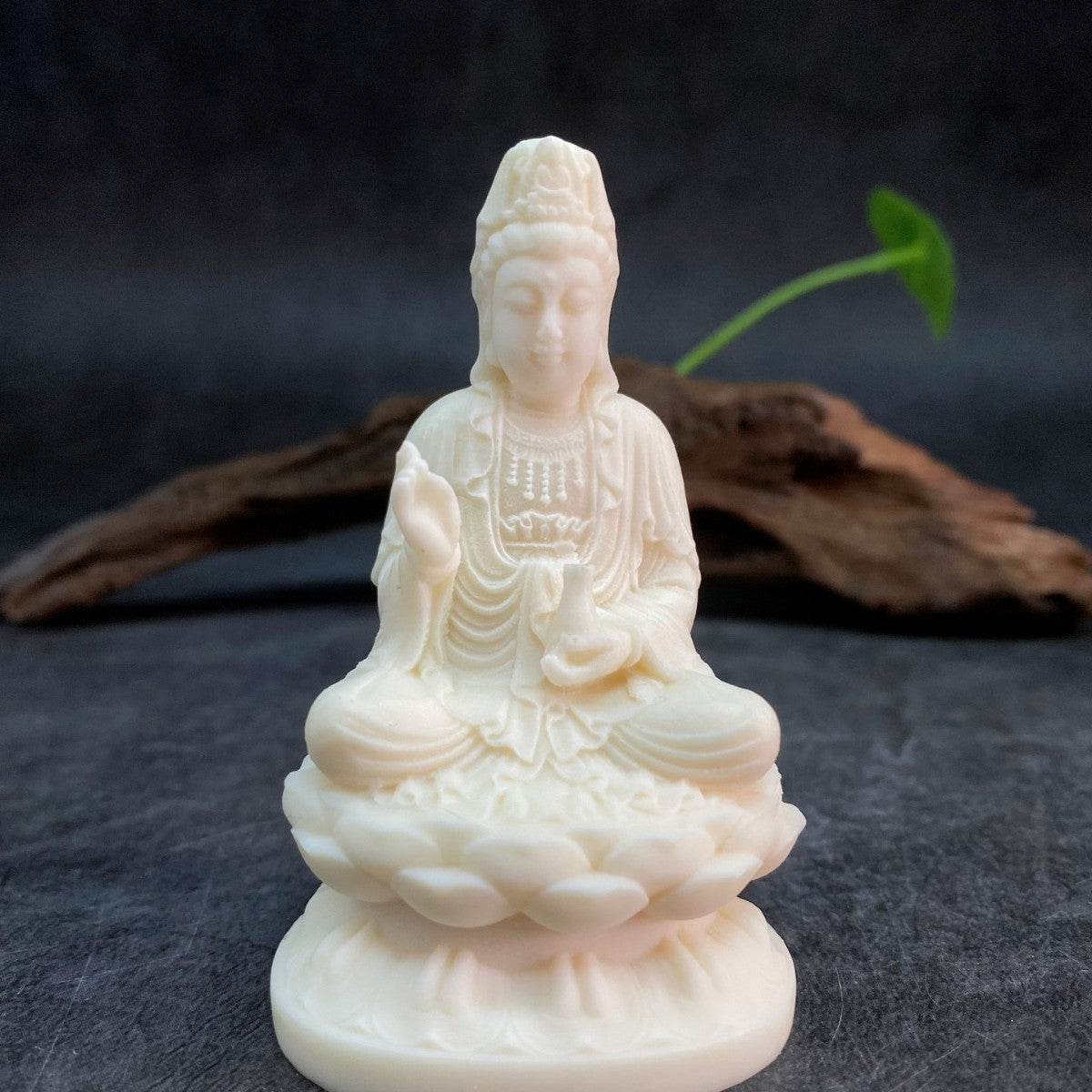 Ivory nut seated Guanyin statue on lotus base in creamy vegetable ivory tone