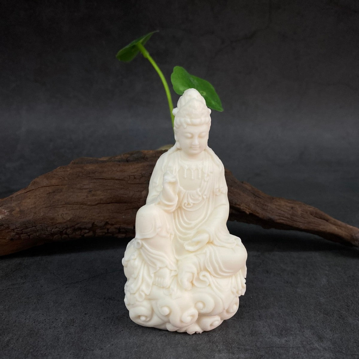 Ivory nut seated Guanyin statue on cloud and lotus-style base in natural creamy finish