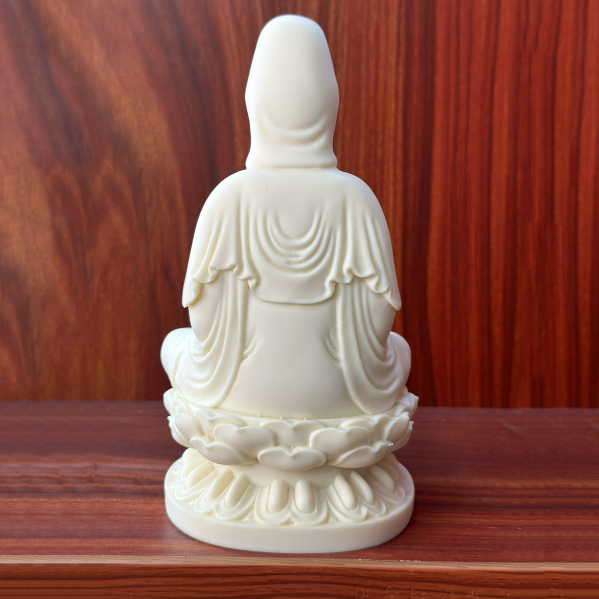 Back view of ivory nut Jingping Guanyin statue with flowing robe and lotus throne