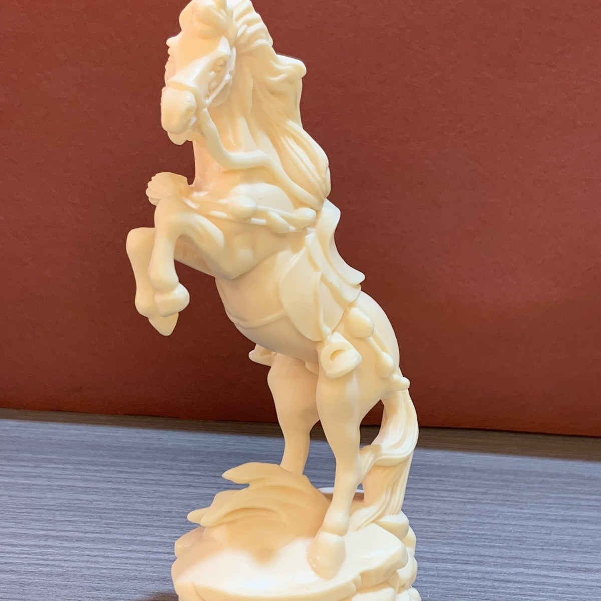 Ivory nut rearing horse sculpture with flowing mane, money charm and decorative base