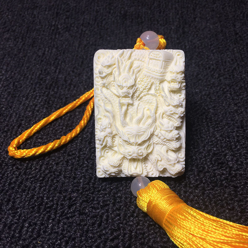 Ivory nut multi-dragon relief carving with golden tassel and bead