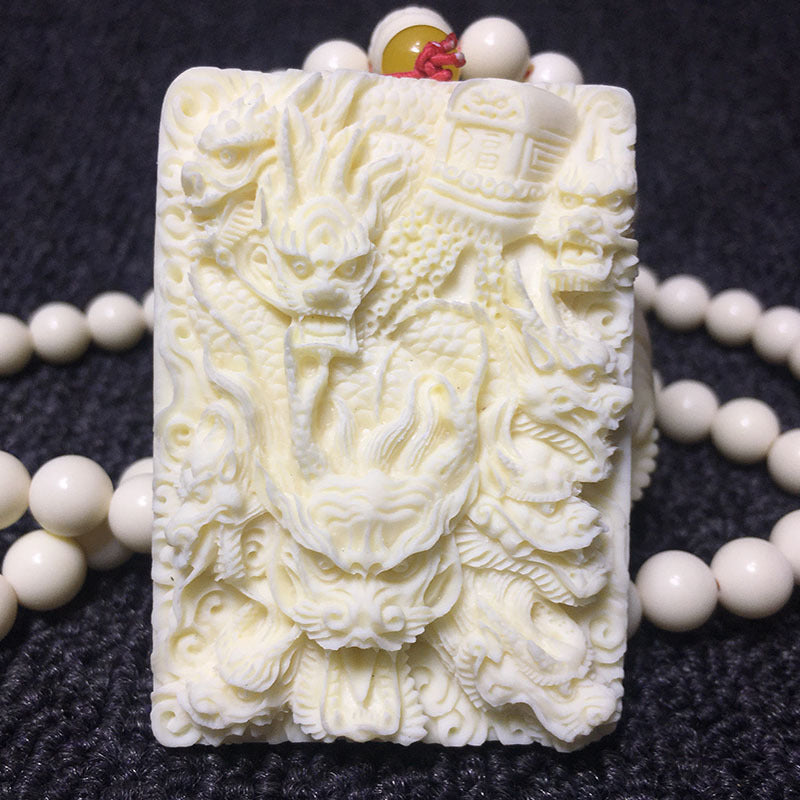 Front close-up of ivory nut multi-dragon fortune relief carving