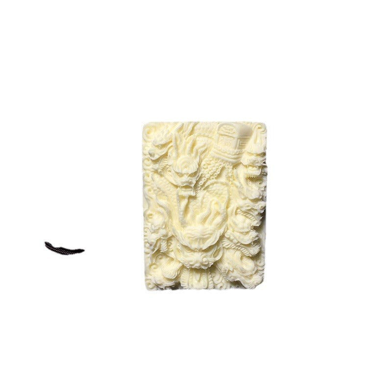 Ivory nut multi-dragon relief pendant product view on white background