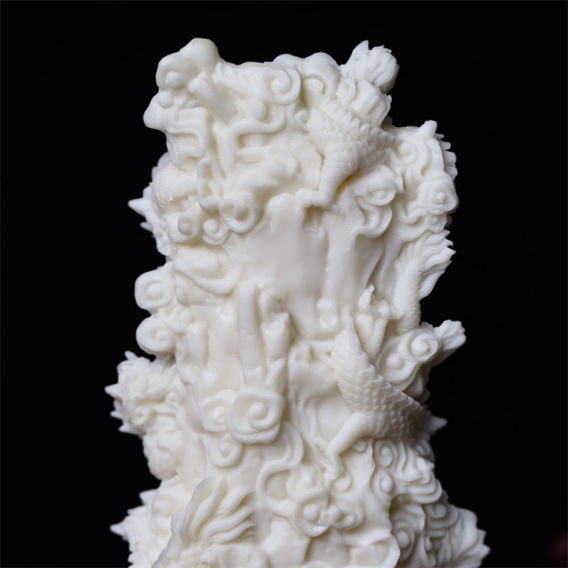 Close detail of Nine Dragon Guanyin vegetable ivory carving with clouds and dragon relief