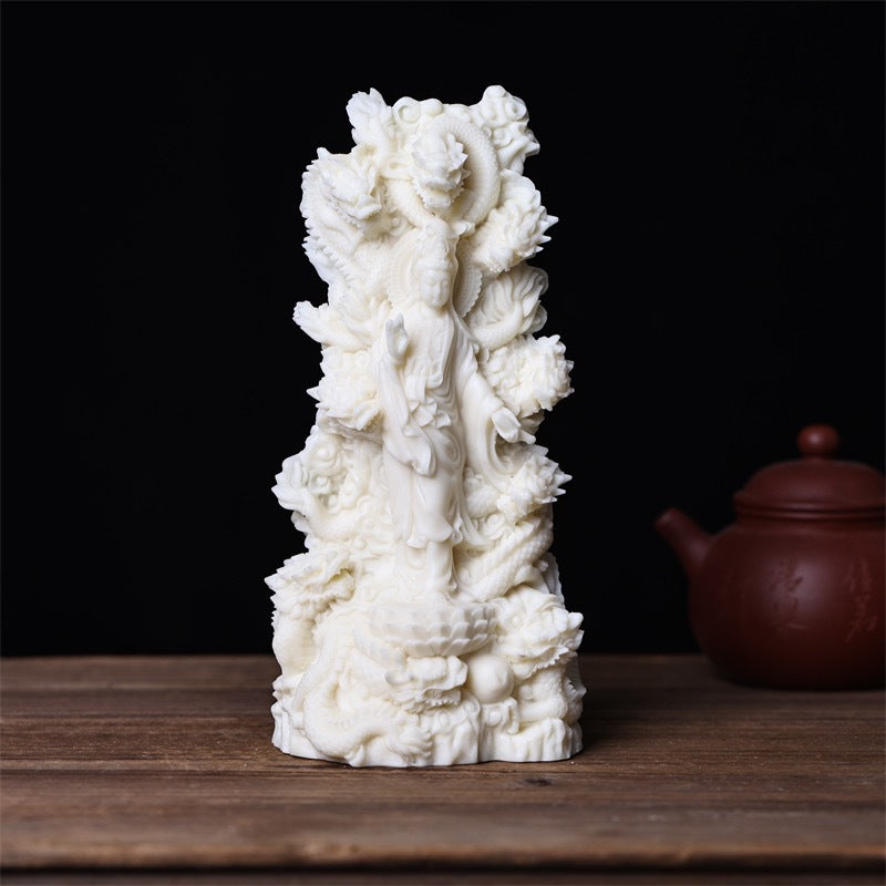 Nine Dragon Guanyin ivory nut statue three-quarter view with layered dragon and lotus details