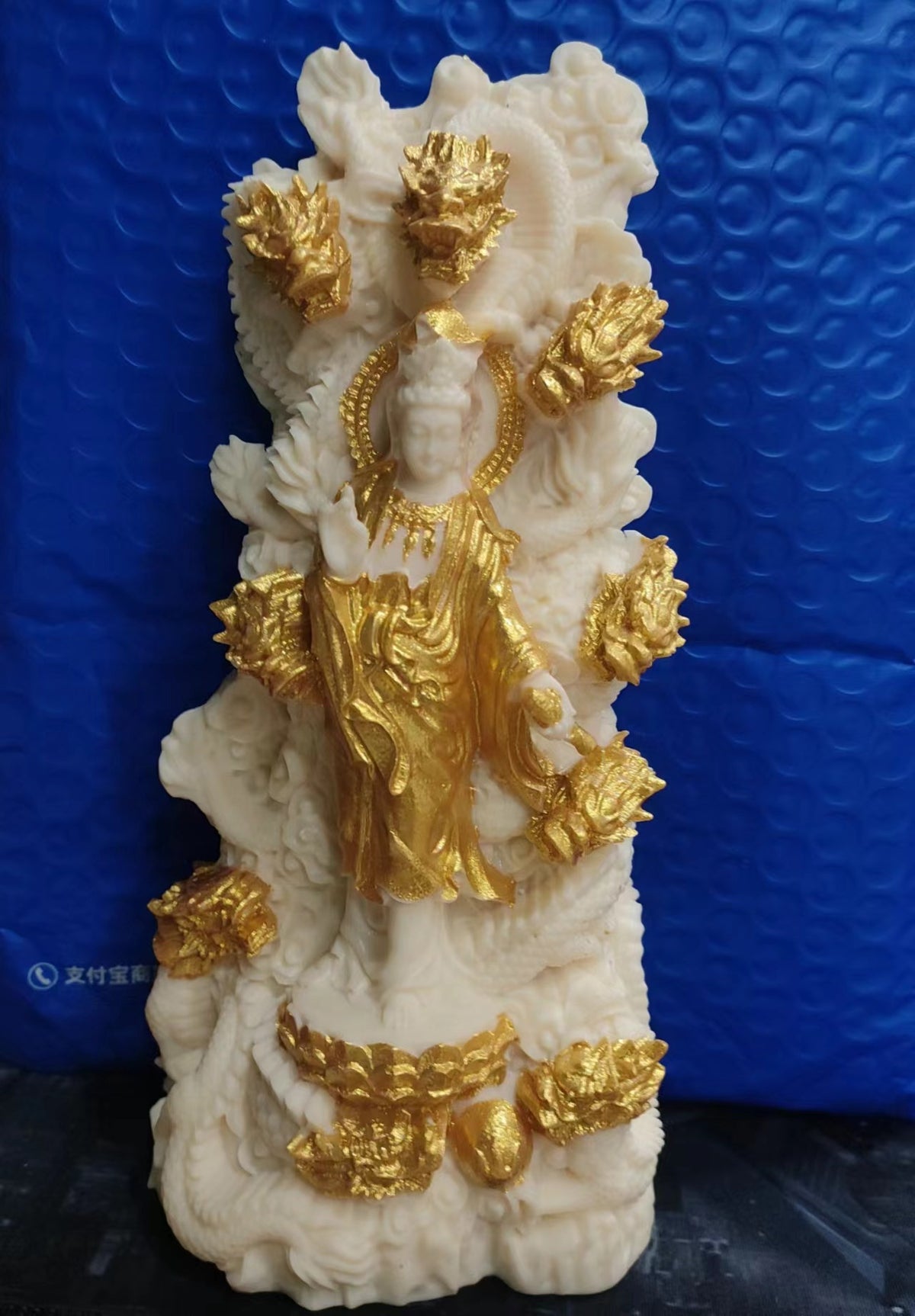 Ivory nut Nine Dragon Guanyin statue sculptural detail with dragon and cloud motifs