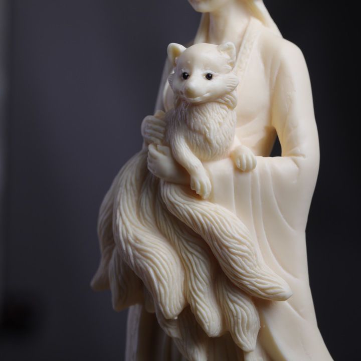 Ivory nut nine-tail fox maiden figurine holding a fox in natural vegetable ivory tone