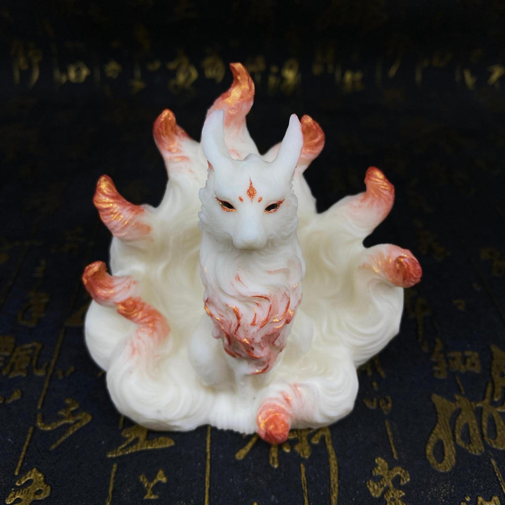 Ivory nut nine-tail fox figurine with rose-gold accent details shown from a front angle