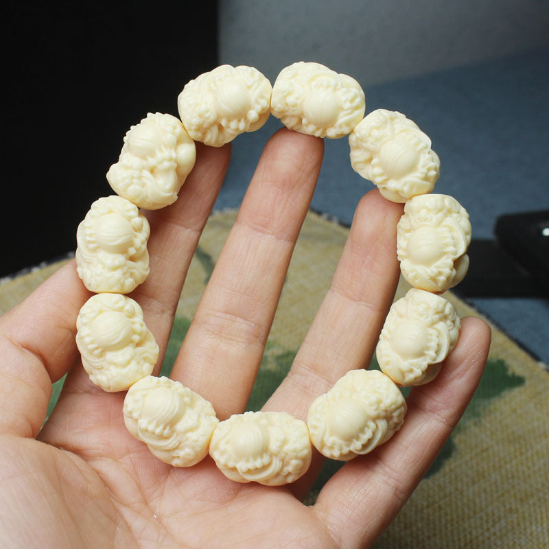 Ivory nut Pixiu carved bead bracelet with creamy botanical ivory tone, approximately 20mm beads
