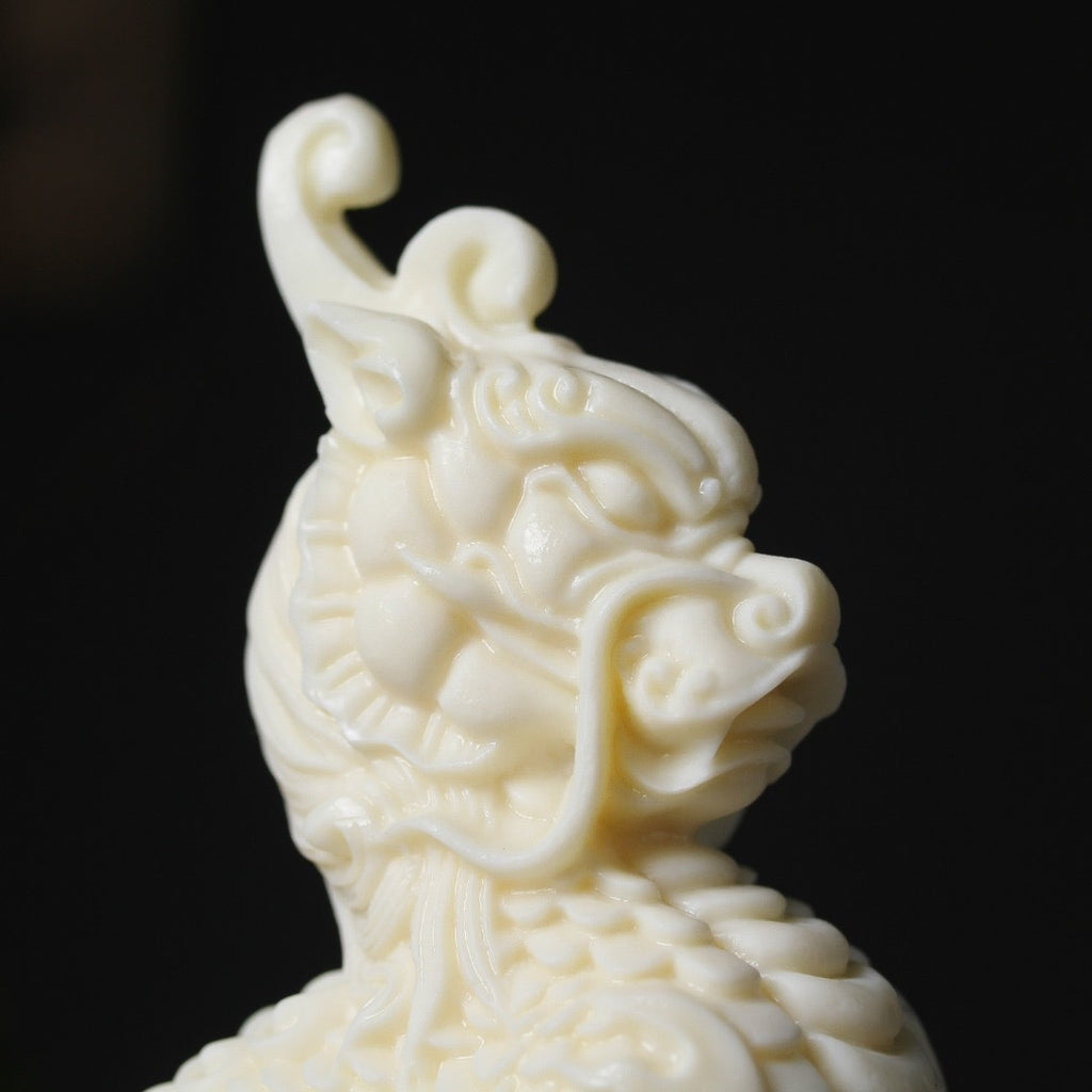 Vegetable ivory Qilin figurine side view with curled horn and carved scales