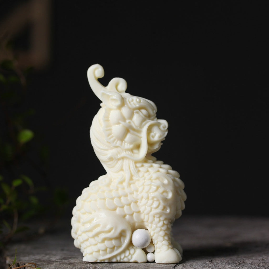 Vegetable ivory Qilin Kirin wealth and auspicious decor figurine on dark background