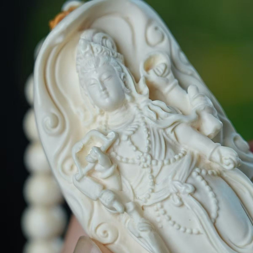 Close-up of ivory nut Samantabhadra bodhisattva relief carving with attendant elephant detail