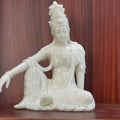 Ivory nut seated Freedom Guanyin decorative statue in relaxed pose, natural creamy vegetable ivory tone