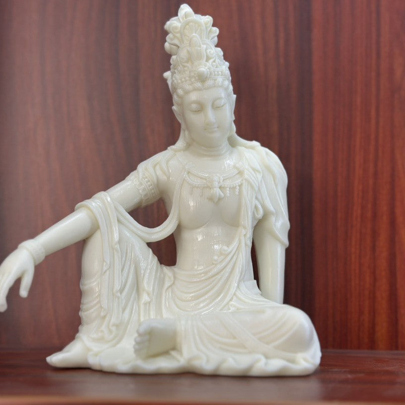 Ivory nut seated Freedom Guanyin decorative statue in relaxed pose, natural creamy vegetable ivory tone
