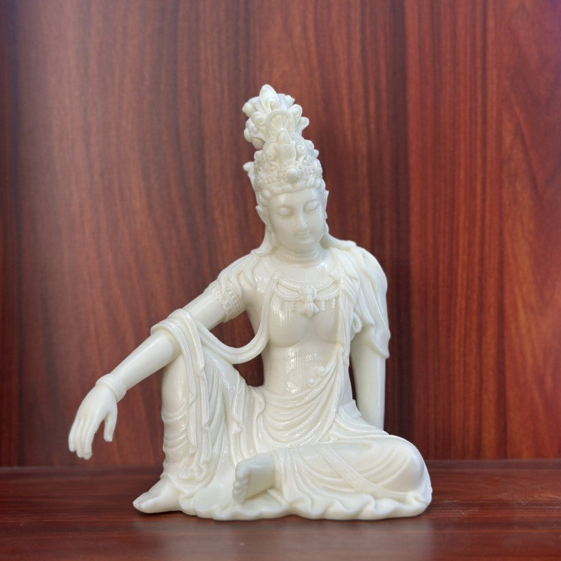 Ivory nut seated Guanyin statue front three-quarter view with ornate headdress and draped robes