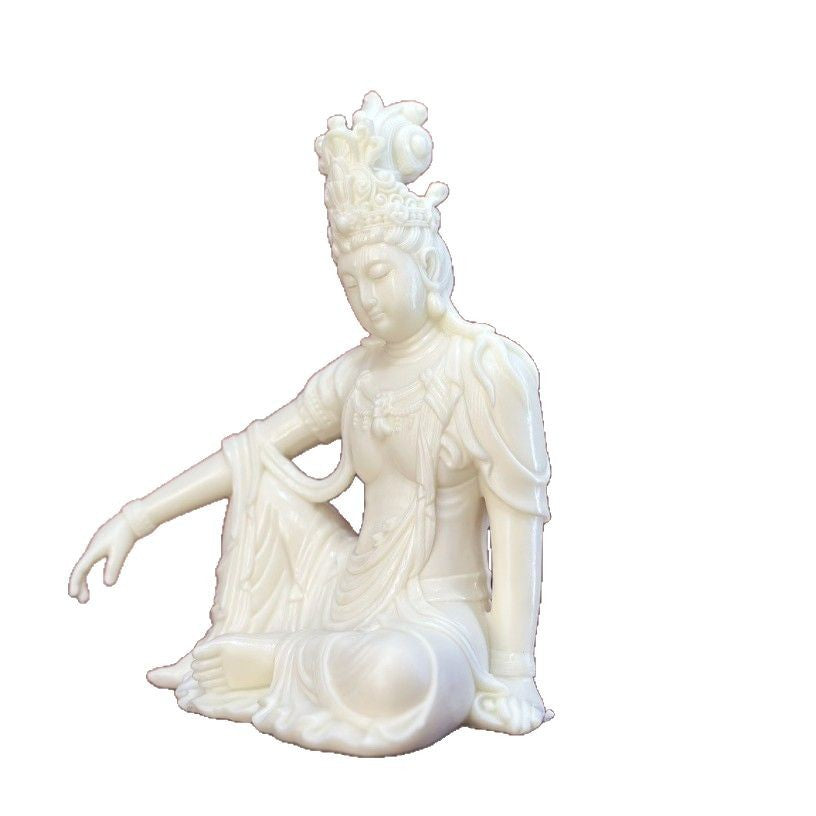 Natural ivory nut seated Guanyin statue isolated on white background