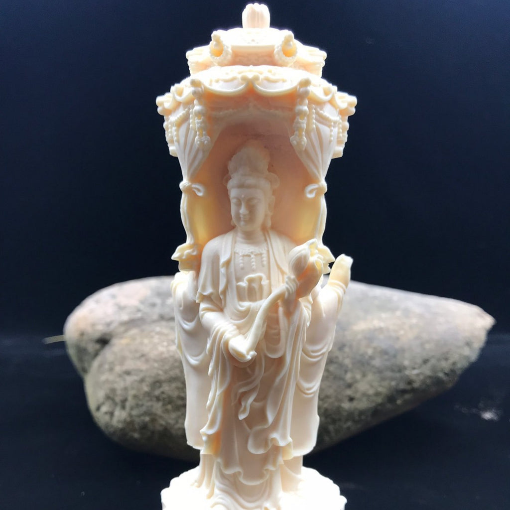 Ivory nut Western Pure Land Three Saints carving shown against stone backdrop