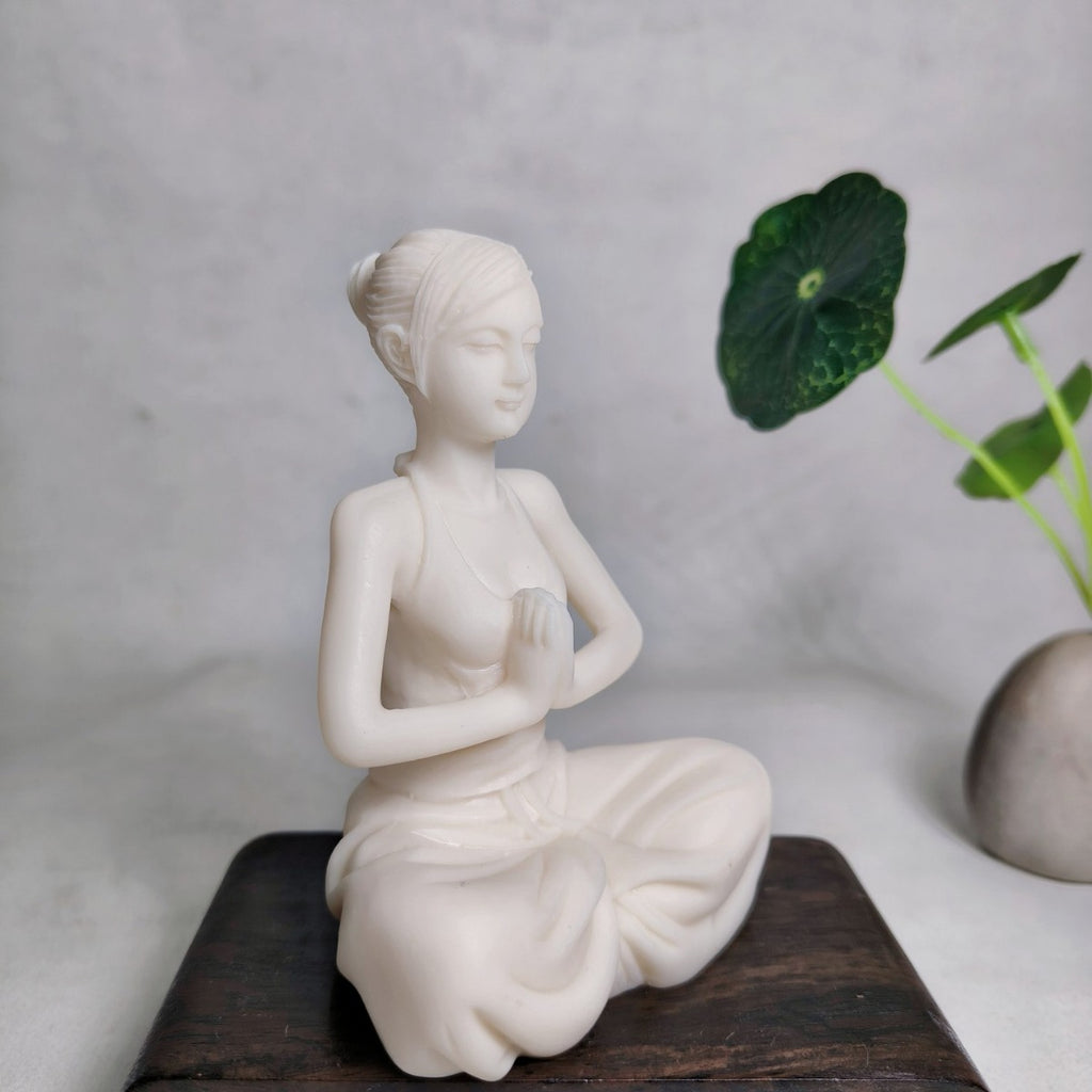 Modern yoga woman vegetable ivory figurine in seated prayer pose, three-quarter view