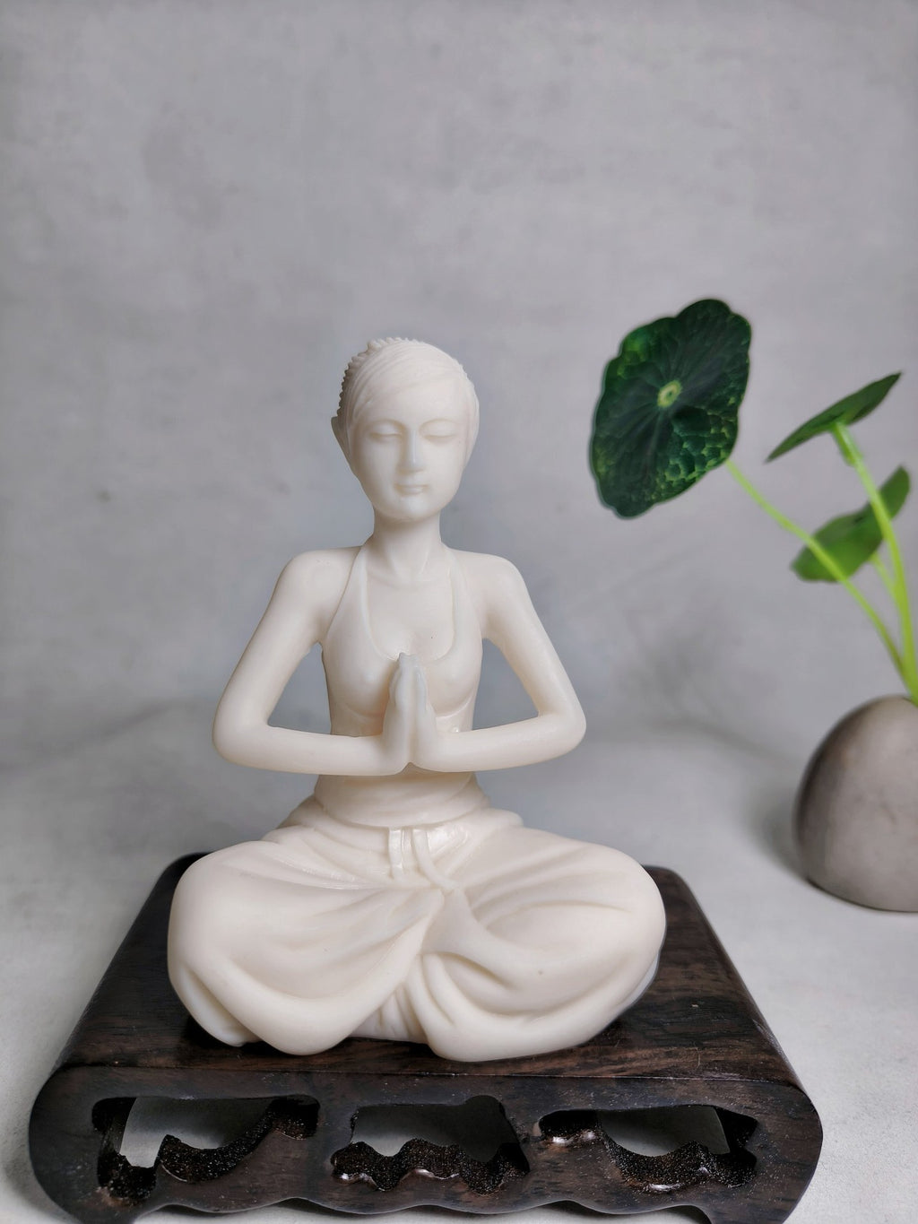 Ivory nut meditation yoga woman decorative sculpture displayed on dark wood stand