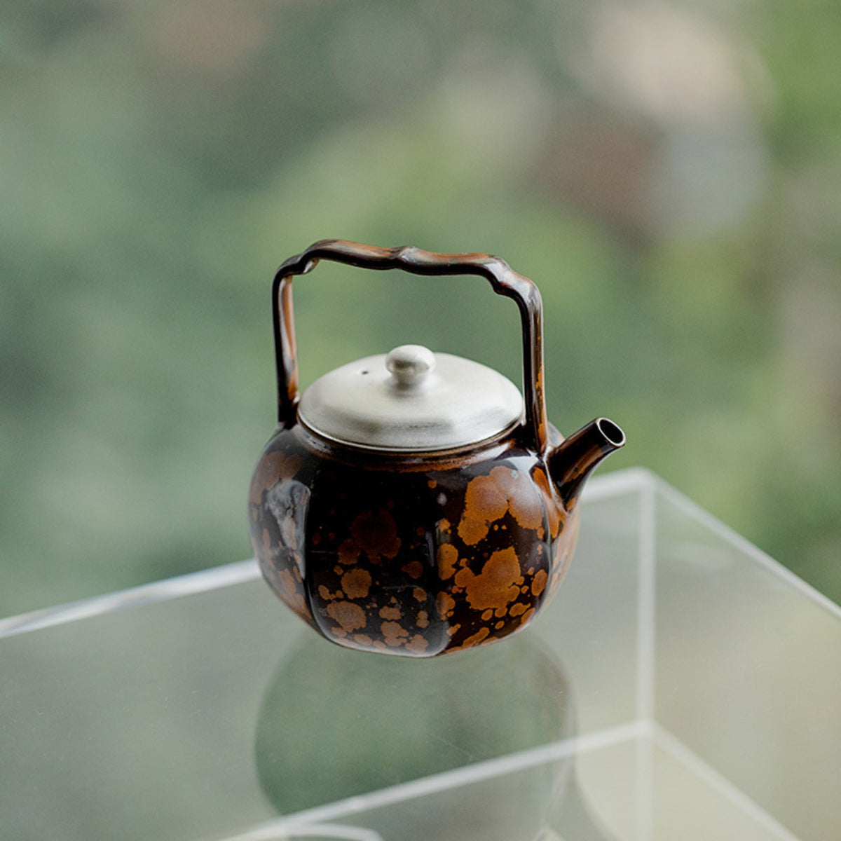 Chestnut brown kiln-transformed ceramic teapot displayed as Chinese tea room decor