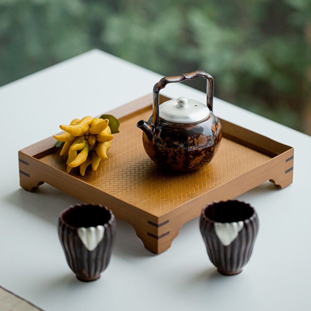Chestnut brown kiln-transformed lift-handle teapot styled on a wooden Chinese tea tray