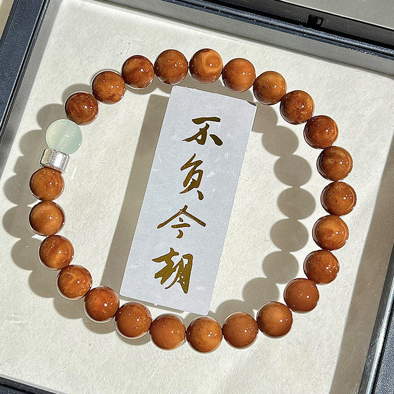 Kuk Bodhi 8mm bracelet with polished brown beads, pale accent beads and gold-tone dragon blessing detail