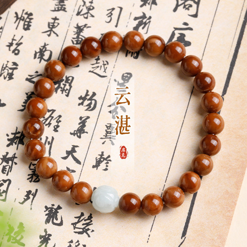 Kuk Bodhi 8mm bracelet with polished brown beads and green accent beads